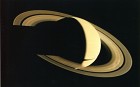 Voyager 1 looked back at Saturn on Nov. 16, 1980, four days after the spacecraft flew past the planet, to observe the appearance of Saturn and its rings from this unique perspective. A few of the spokelike ring features discovered by Voyager appear in the rings as bright patches in this image, taken at a distance of 5.3 million kilometers (3.3 million miles) from the planet